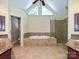 Primary bathroom featuring a soaking tub, glass shower, and granite counters at 16511 Bridgehampton Club Dr, Charlotte, NC 28277