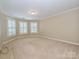 Bedroom with neutral carpet, plantation shutters, and ample natural light at 16511 Bridgehampton Club Dr, Charlotte, NC 28277