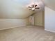 Bedroom with neutral carpet, vaulted ceilings, and access to a closet at 16511 Bridgehampton Club Dr, Charlotte, NC 28277