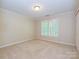Bedroom with neutral carpet and plantation shutters at 16511 Bridgehampton Club Dr, Charlotte, NC 28277