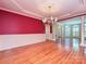 Spacious dining room with hardwood floors, chandelier, and adjacent sitting area at 16511 Bridgehampton Club Dr, Charlotte, NC 28277