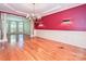 Formal dining area with hardwood floors, decorative chandelier, and elegant wainscoting at 16511 Bridgehampton Club Dr, Charlotte, NC 28277