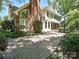 Two-story home boasting a brick chimney, brick accents, and a spacious paved driveway at 16511 Bridgehampton Club Dr, Charlotte, NC 28277