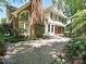 Two-story home boasting a brick chimney, brick accents, and a spacious paved driveway at 16511 Bridgehampton Club Dr, Charlotte, NC 28277