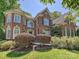 A stately brick home featuring manicured landscaping and timeless architectural details at 16511 Bridgehampton Club Dr, Charlotte, NC 28277