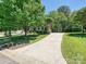 A well-manicured front yard leads to this brick home with mature trees and nice landscaping at 16511 Bridgehampton Club Dr, Charlotte, NC 28277