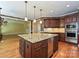 Beautiful kitchen with an oversized island, stainless steel appliances and hardwood flooring at 16511 Bridgehampton Club Dr, Charlotte, NC 28277