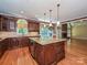 Open kitchen featuring stainless steel appliances, an island with granite countertops, and hardwood flooring at 16511 Bridgehampton Club Dr, Charlotte, NC 28277