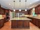 Large kitchen with an island, granite counters, and stainless steel appliances at 16511 Bridgehampton Club Dr, Charlotte, NC 28277