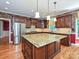 Gourmet kitchen featuring granite countertops, an island, and stainless steel refrigerator at 16511 Bridgehampton Club Dr, Charlotte, NC 28277