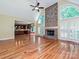 Spacious living room boasting a stone fireplace, high ceilings, and kitchen view at 16511 Bridgehampton Club Dr, Charlotte, NC 28277