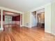 Open-concept floor plan showcasing the living and dining spaces with hardwood flooring at 16511 Bridgehampton Club Dr, Charlotte, NC 28277