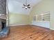 Bright open living room boasting a striking stone fireplace, vaulted ceilings, hardwood floors, and built-in shelving at 16511 Bridgehampton Club Dr, Charlotte, NC 28277