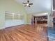 Open living room featuring built-in shelving, fireplace, and a view into the kitchen at 16511 Bridgehampton Club Dr, Charlotte, NC 28277