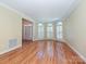 Bright living room with hardwood floors, large windows, and natural light at 16511 Bridgehampton Club Dr, Charlotte, NC 28277