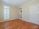 Bright office with hardwood floors, white trim, and a large window with shutter blinds at 16511 Bridgehampton Club Dr, Charlotte, NC 28277