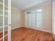 A bright office with hardwood floors, white trim, and a large window with shutter blinds at 16511 Bridgehampton Club Dr, Charlotte, NC 28277