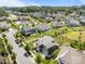 Aerial view of a vibrant community with lush green spaces, a playground, and well-maintained homes at 17513 Julees Walk Ln, Davidson, NC 28036