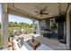 Relax on the covered patio with fan, outdoor seating, grill, and enjoy views of the spacious fenced backyard at 17513 Julees Walk Ln, Davidson, NC 28036