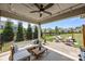 Enjoy outdoor living with a covered patio, ceiling fan, outdoor seating, grill and spacious fenced backyard at 17513 Julees Walk Ln, Davidson, NC 28036