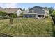 A spacious, fenced backyard with lush grass and a patio area, ideal for outdoor gatherings and relaxation at 17513 Julees Walk Ln, Davidson, NC 28036