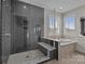 A modern bathroom featuring a glass enclosed shower and a soaking tub with tiled accents at 17513 Julees Walk Ln, Davidson, NC 28036