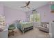 A charming bedroom with pastel-painted walls and ample natural light from the large windows at 17513 Julees Walk Ln, Davidson, NC 28036