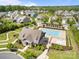 Aerial view of the community pool, clubhouse, playground, and mature trees in a Gathering-friendly neighborhood at 17513 Julees Walk Ln, Davidson, NC 28036