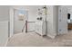 A hallway with carpet, white railing, and storage cabinet at 17513 Julees Walk Ln, Davidson, NC 28036