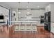Bright kitchen features white cabinets, a large island with seating, and stainless steel appliances at 17513 Julees Walk Ln, Davidson, NC 28036