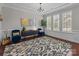 Formal living room with decorative rug, accent chairs, and bright light from windows at 17513 Julees Walk Ln, Davidson, NC 28036