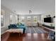 A well-lit living room features hardwood floors, a comfortable sofa, and bright natural light at 17513 Julees Walk Ln, Davidson, NC 28036