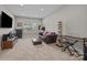 A recreation room featuring a leather sofa and a stack of books near a piano at 17513 Julees Walk Ln, Davidson, NC 28036