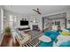 An open living room with hardwood floors, a cozy fireplace, and lots of bright natural light at 17513 Julees Walk Ln, Davidson, NC 28036