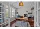 A bright office features a modern desk, multiple monitors, and a geometric rug on hardwood floors at 17513 Julees Walk Ln, Davidson, NC 28036