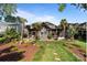 Stunning back exterior with covered patio, stone accents, and lush landscaped yard at 17819 John Connor Rd, Cornelius, NC 28031
