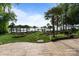 Beautiful backyard with stone patio, manicured lawn, walkway, palm trees, and waterfront views at 17819 John Connor Rd, Cornelius, NC 28031