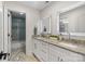 Bright bathroom with granite counters, dual sinks, and tiled shower at 17819 John Connor Rd, Cornelius, NC 28031