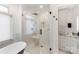Bright bathroom featuring a glass shower, soaking tub, and marble accents at 17819 John Connor Rd, Cornelius, NC 28031