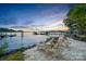 Inviting beachfront with lounge chairs and tranquil waters at sunset at 17819 John Connor Rd, Cornelius, NC 28031