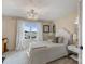 Comfortable bedroom featuring plush carpet, stylish lighting, and a scenic lake view at 17819 John Connor Rd, Cornelius, NC 28031