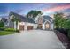 Beautiful home with three-car garage, stone accents, and a spacious driveway at 17819 John Connor Rd, Cornelius, NC 28031