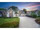 Stunning home exterior featuring stone accents, manicured lawn, and circular driveway at 17819 John Connor Rd, Cornelius, NC 28031