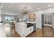 Spacious kitchen island with a black sink, white marble countertops, and stainless appliances at 17819 John Connor Rd, Cornelius, NC 28031