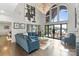 Bright living room with high ceilings, chandelier, and access to outdoor patio at 17819 John Connor Rd, Cornelius, NC 28031