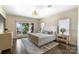 Bright main bedroom offers lake views, custom window treatments, and sophisticated decor at 17819 John Connor Rd, Cornelius, NC 28031
