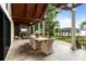 Inviting outdoor dining area with covered patio and serene views at 17819 John Connor Rd, Cornelius, NC 28031