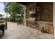 Outdoor kitchen featuring stone facade, stainless steel appliances, and lake view at 17819 John Connor Rd, Cornelius, NC 28031