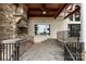 Outdoor kitchen features a stone facade, stainless steel appliances, and lake view at 17819 John Connor Rd, Cornelius, NC 28031