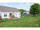 Expansive backyard features a patio with furniture, a well-kept lawn, and mature trees at 179 Foy Ln, Statesville, NC 28625